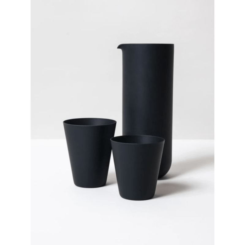 black pottery water glass and pitcher